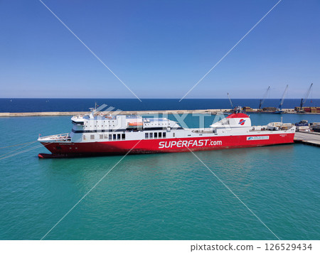 Bari, Italy - May 10, 2025: Aerial view of a Superfast Ferry. It is a Greece-based ferry company. The ship is anchored in the port of the Apulian city. 126529434