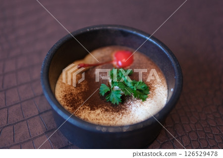 Home-made Highland Tiramisu Creme Perfect ready-to-eat homemade tiramisu cake with fresh mint. Tiramisu portion on pink plate over white marble background. Delicious Home-made Highland Tiramisu Creme Perfect ready-to-eat homemade tiramisu cake with fresh mint. Tiramisu portion on pink plate over white marble background. Delicious 126529478