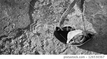 An antique leather sling lies on the ground An antique leather sling lies on the ground 126530367