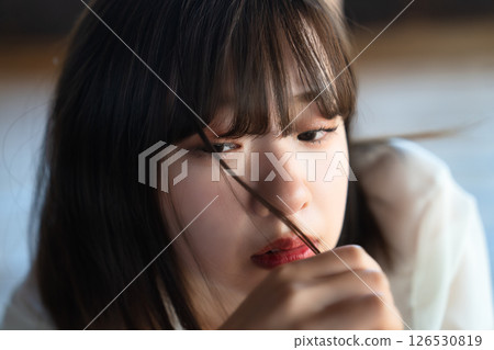 Young woman lying on flooring Young woman lying on flooring 126530819