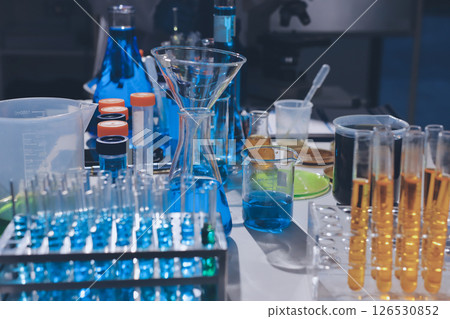 Scientist pipetting medical samples into microplate in laboratory 126530852
