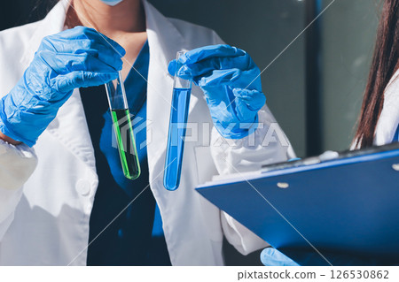 Scientist pipetting medical samples into microplate in laboratory Scientist pipetting medical samples into microplate in laboratory 126530862
