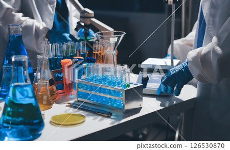 Scientist pipetting medical samples into microplate in laboratory Scientist pipetting medical samples into microplate in laboratory 126530870