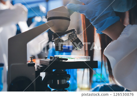 Scientist pipetting medical samples into microplate in laboratory Scientist pipetting medical samples into microplate in laboratory 126530876