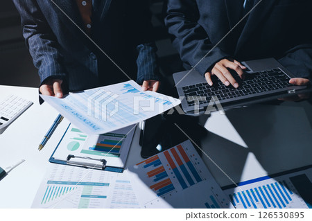 Two business people analyzing the data Two business people analyzing the data 126530895