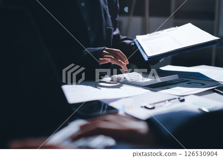 Group of business women working on a financial data expenses document. 126530904