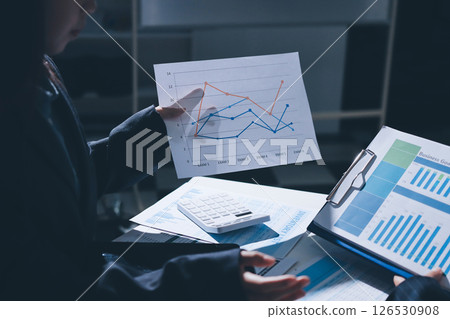 Group of business women working on a financial data expenses document. 126530908
