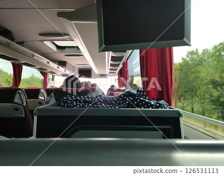 Group of tourist sitting in the bus and looking through the windows at forest 126531113