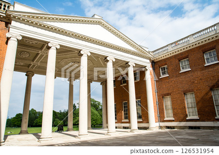 Osterley House, a historic building with red bricks and white stone pillars, on the outskirts of London Osterley House, a historic building with red bricks and white stone pillars, on the outskirts of London 126531954