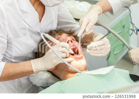 Dental procedure during an examination with a young patient in a modern clinic setting 126531998