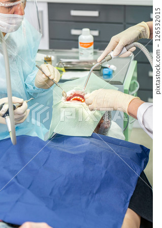 Dental procedure in a modern clinic focusing on patient care and advanced technology Dental procedure in a modern clinic focusing on patient care and advanced technology 126532015