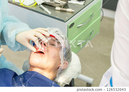 Dental cleaning procedure in a clinic with focus on plaque removal and teeth whiteness 126532043