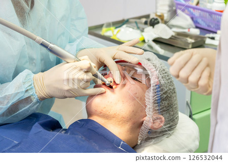 Dental cleaning procedure in a clinic with focus on plaque removal and teeth whiteness Dental cleaning procedure in a clinic with focus on plaque removal and teeth whiteness 126532044
