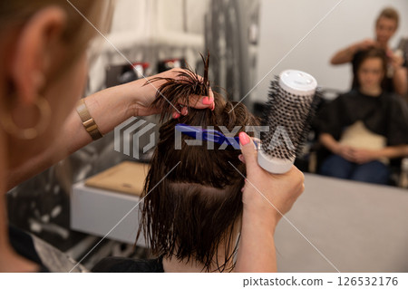 Watch Hair Styling in Action at a Salon, where beauty and expertise come together beautifully Watch Hair Styling in Action at a Salon, where beauty and expertise come together beautifully 126532176