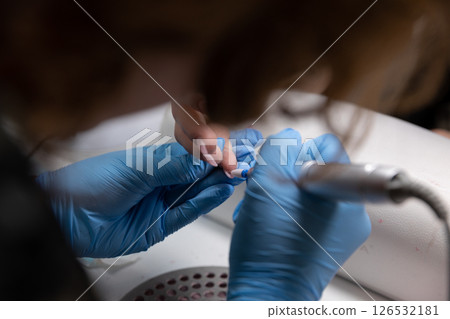 The Professional Nail Care Treatment is Currently Underway and is Actively in Progress 126532181