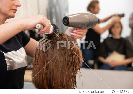 Experience Professional Hair Drying Services in a Luxurious Salon Setting for All Clients 126532222