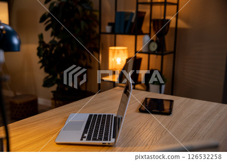 Create a Cozy Home Office Setup Featuring a Laptop and Tablet for Productive Work Days Create a Cozy Home Office Setup Featuring a Laptop and Tablet for Productive Work Days 126532258