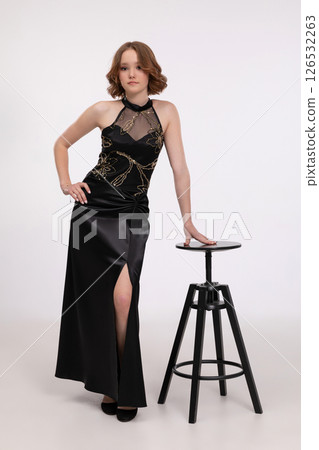 An Elegant Young Woman Dressed in a Chic and Stylish Black Dress Posing with Confidence An Elegant Young Woman Dressed in a Chic and Stylish Black Dress Posing with Confidence 126532263