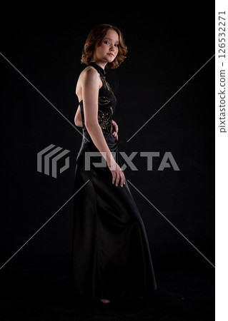 An Elegant Fashion Model Dressed in a Stunning Black Evening Dress, Exuding Style and Grace An Elegant Fashion Model Dressed in a Stunning Black Evening Dress, Exuding Style and Grace 126532271