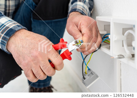 Electrician at work on a residential electrical system. Electricity. 126532448