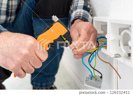 Electrician at work on a residential electrical system. Electricity. 126532451