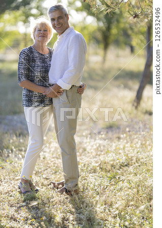 Happy senior couple embracing in sunny summer nature 126532496