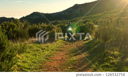 Enduro Motorcycle Rider Driving in High Mountain Landscape, Madeira Island , Portugal Enduro Motorcycle Rider Driving in High Mountain Landscape, Madeira Island , Portugal 126532758