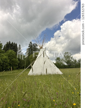 Teepee is in a field of grass Teepee is in a field of grass 126532763