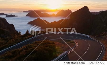 Epic Sunset View in High Mountain Landscape with Asphalt Road . Pico do Arieiro , Madeira Island . Clouds in the Valley . 126532772