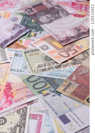 A background consisting of paper banknotes of different currencies 126532922