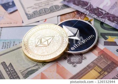 Round metal ethereum on a background of paper banknotes Round metal ethereum on a background of paper banknotes 126532944