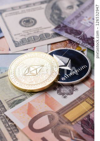 Round metal ethereum on a background of paper banknotes Round metal ethereum on a background of paper banknotes 126532947