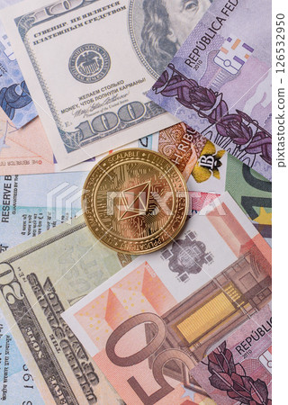 Round metal ethereum on a background of paper banknotes 126532950