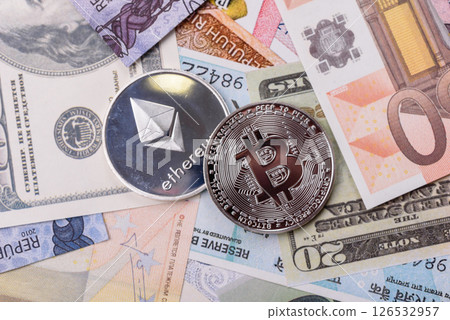 Round metal ethereum on a background of paper banknotes Round metal ethereum on a background of paper banknotes 126532957