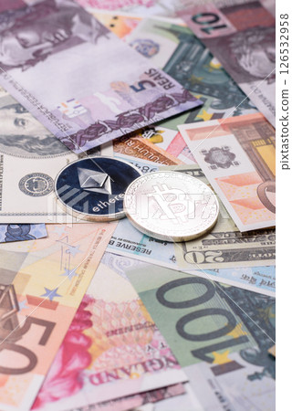 Round metal ethereum on a background of paper banknotes Round metal ethereum on a background of paper banknotes 126532958