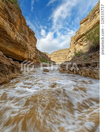 Rapid River Flowing Through Rocky Canyon Dramatic Nature Scene Golden Hour Light Sky Blue Fast Blur 126533757