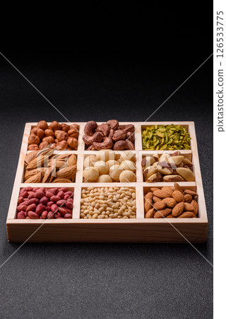 Mix of macadamia, pine, cashew, hazelnut, peanut, pistachio nuts 126533775