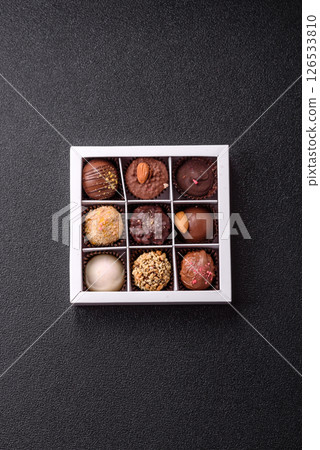 Homemade chocolate candies with different fillings and sprinkles 126533810