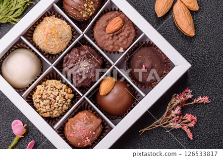 Homemade chocolate candies with different fillings and sprinkles Homemade chocolate candies with different fillings and sprinkles 126533817