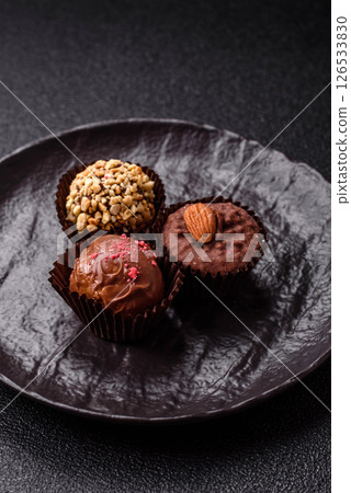 Homemade chocolate candies with different fillings and sprinkles 126533830