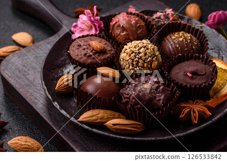 Homemade chocolate candies with different fillings and sprinkles Homemade chocolate candies with different fillings and sprinkles 126533842