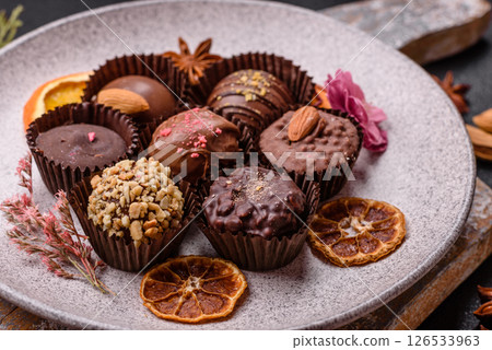 Homemade chocolate candies with different fillings and sprinkles 126533963