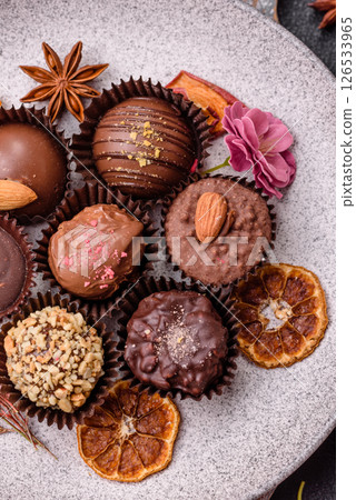 Homemade chocolate candies with different fillings and sprinkles Homemade chocolate candies with different fillings and sprinkles 126533965