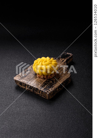 Round sweet tart of yellow color with citrus and passion fruit flavor Round sweet tart of yellow color with citrus and passion fruit flavor 126534010