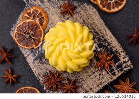 Round sweet tart of yellow color with citrus and passion fruit flavor 126534016