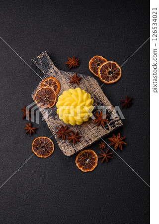 Round sweet tart of yellow color with citrus and passion fruit flavor 126534021