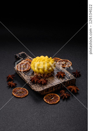 Round sweet tart of yellow color with citrus and passion fruit flavor 126534022