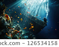 Scuba diver navigates the underwater world, exploring a decaying shipwreck teeming with colorful fish and vibrant coral, showcasing the beauty and mystery of the deep sea 126534158