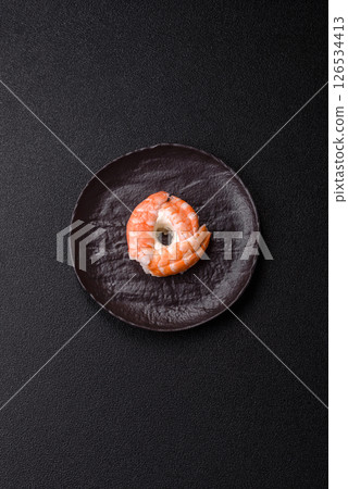 Donut shaped sushi rolls with salmon, shrimp and tuna 126534413
