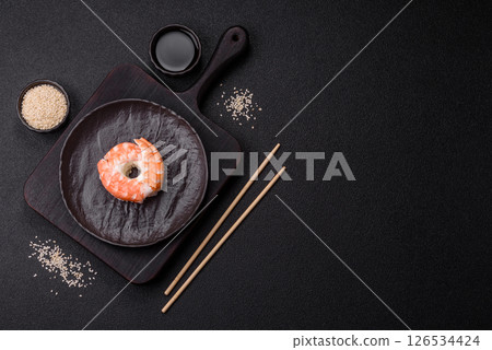 Donut shaped sushi rolls with salmon, shrimp and tuna Donut shaped sushi rolls with salmon, shrimp and tuna 126534424